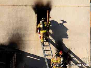 Fire rescue and police investigating fire at abandoned Edmonton apartment