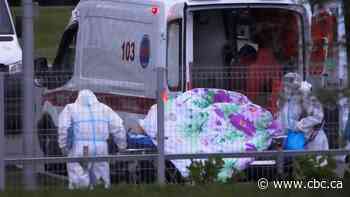 Russia tops 1,000 new deaths for the 1st time amid record COVID-19 surge