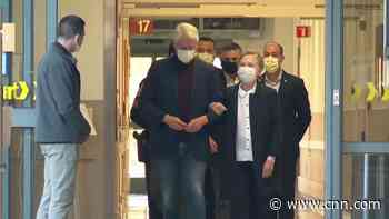 Bill Clinton walks out of hospital with Hillary by his side