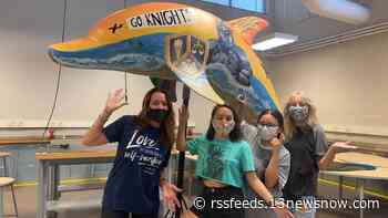 MAKING A MARK: Students decorate dolphin statue in support of Operation Smile