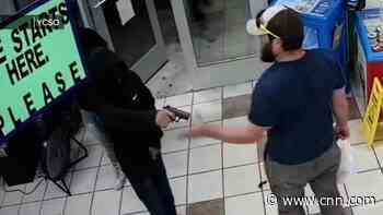 Surveillance video shows Marine verteran stop armed robbery