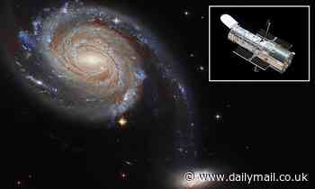 Space: Hubble telescope spots two 'squabbling' galaxies locked in a cosmic dance