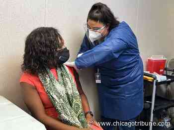 After getting her booster shot in Aurora, Illinois Public Health director urges everyone to get vaccinated against COVID-19 - Chicago Tribune