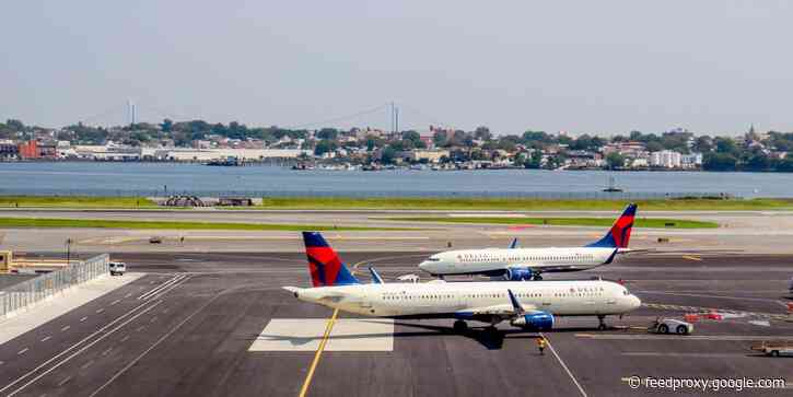 A Delta passenger was arrested after allegedly punching the person behind him over a seating dispute, Atlanta police say