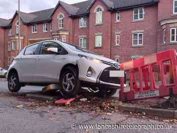 Blackburn: Car crashes into traffic island during rush hour