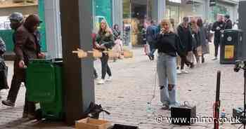 Busker's kind act to homeless man searching bin for food repaid just seconds later - The Mirror