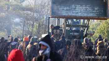 Migrants stuck at Poland-Belarus border deal with dropping temperatures as tensions rise