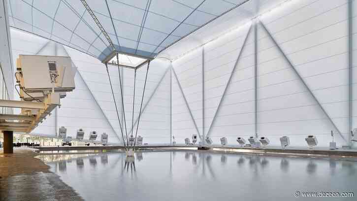 Visitors wade through water in the Brazilian Pavilion at Expo Dubai 2020