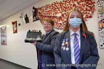 Pupils proudly display dad's service medals at remembrance event