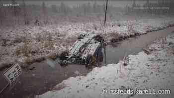 Linemen jump into icy water to save a young mother trapped in a sinking car