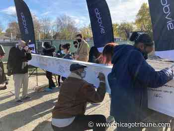 Dozens involved in North Chicago middle school project sign beam; 'This will be the legacy of the many, many hands who were part of this' - Chicago Tribune