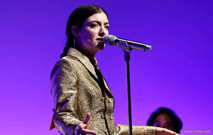 Lorde performs while peeling fruit at the Guggenheim International Gala