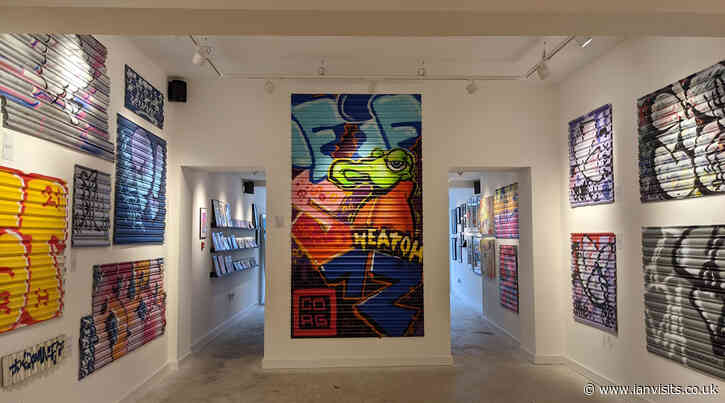 Graffiti covered shop shutters fills an art gallery