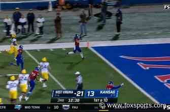 Gavin Potter’s Pick-Six sets up a 2-PT conversion for Kansas to even the score against West Virginia, 21-21