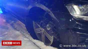 Bradford driver stopped in snow with tyre 'hanging off' - BBC News