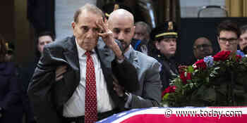 Watch the moment Bob Dole, 95, rose from his wheelchair to salute George H.W. Bush