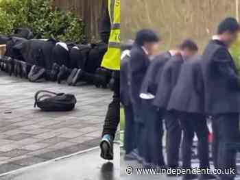 School apologises after Muslim students pictured praying outside in cold weather - The Independent