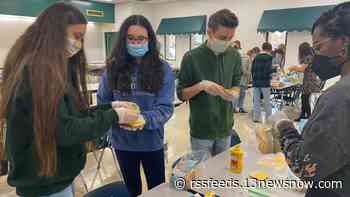 Cox High School students assemble over 1,800 sandwiches for those in need