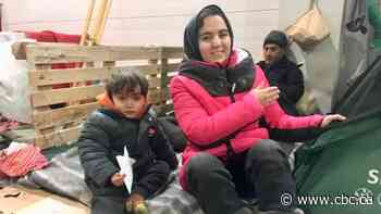 Mere steps from the EU, hundreds of migrants remain stranded in Belarusian warehouse