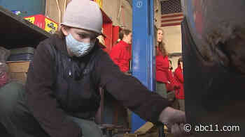 Female mechanic teaches girl scout troop basic car maintenance