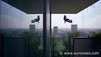 Flying gardeners defy gravity to keep Milan's vertical forest alive - Euronews