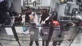 Airport security officer leaps conveyor belt to help choking baby