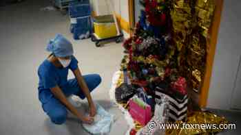 Surging COVID cases, ‘jingle jabs’ make for somber Christmas