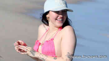 Noah Cyrus hits the beach in hot pink bikini ahead of sister Miley's New Year's Eve gig in Miami