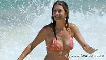'Emily in Paris' star Kate Walsh makes a splash in orange bikini with beau Andrew Nixon at Australia beach