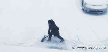 Man's photo of his wife shoveling snow is sparking a heated debate