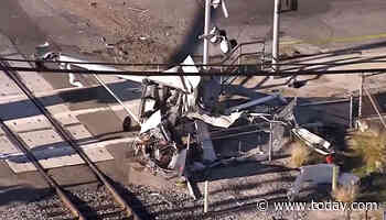 Officers pull pilot from crashed plane seconds before train slams into it