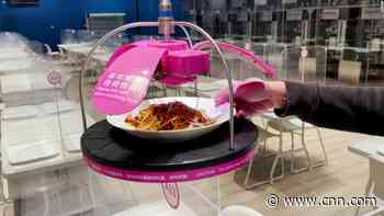 Early Olympics attendees eat noodles served from ceiling