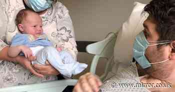 Adorable moment dad meets newborn son for first time 5 weeks after Covid coma