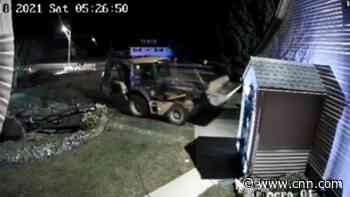Video shows officer fatally shoot a man who was driving a backhoe into homes and cars