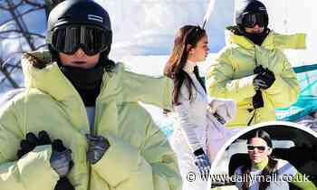 Kendall Jenner bundles up in a neon green puffer jacket as she snowboards with friends in Aspen