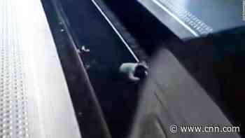 Train narrowly avoids woman pushed onto tracks