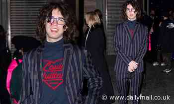 Mick Jagger's son Lucas, 22, dons a suave striped suit as he arrives for Louis Vuitton's show