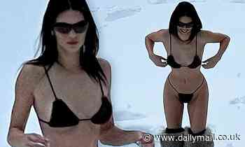 Kendall Jenner plays in the snow wearing a tiny black string bikini while on holiday in Aspen