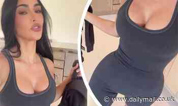 Kim Kardashian showcases her eye-popping cleavage and tiny waist in skin-tight SKIMS bodysuit  
