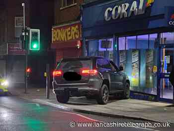 Driver of stolen vehicle crashes into betting shop during police chase