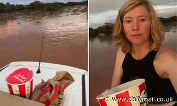 Tiktok video shows woman eat KFC on roof of car after becoming stranded in flooded creek
