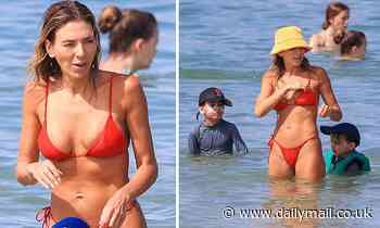 AFL WAG Nadia Bartel sizzles in a red bikini during a holiday at Noosa Beach with her sons