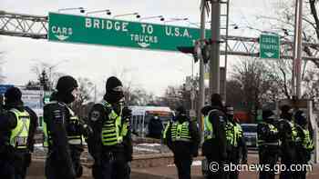 Police in riot gear block trucker protest area on US-Canada border