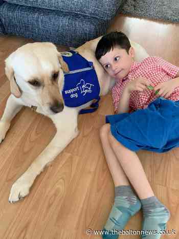 Seven-year-old boy's life transformed by autism assistance dog - The Bolton News