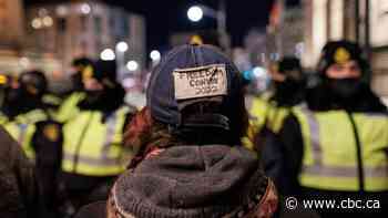 Standoff between protesters and massive police operation stretches into night