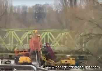 Digger hits bridge after being swept away by swollen river