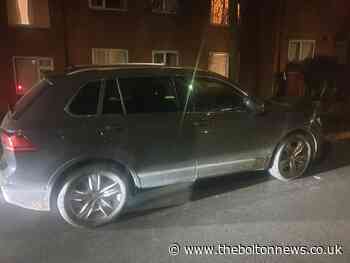 Burgled car abandoned in middle of Bolton road as gang flee into estate