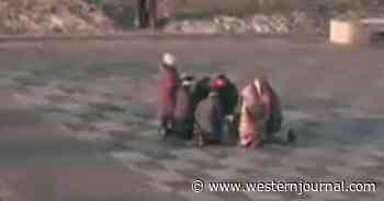 Watch: Ukrainians Kneel in Prayer on Street as Explosions Reported, Russia Invades