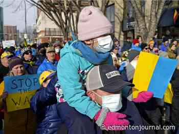 Blue and yellow human chain lines Edmonton streets in support of Ukraine