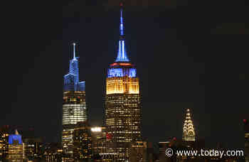 World landmarks lit blue and yellow in solidarity with Ukraine